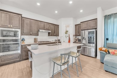 Kitchen with stainless steel appliances, a sink, 