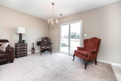 Living area featuring carpet flooring and a chande