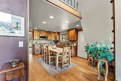 Dining space with recessed lighting, light wood-style floors, and a textured wall