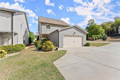 View of front of house with concrete driveway, an 