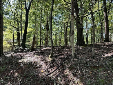 This 1.47 acre lot is in Bent Tree, Jasper, GA.  This lot sits close to the back gate, and will have seasonal views once the lot is cleared for building. This lot will lend well to a basement floor plan.