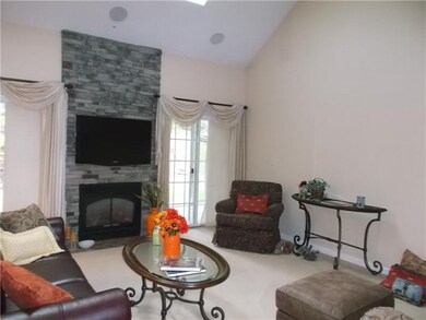 Floor to ceiling stone fireplace with cathedral ce