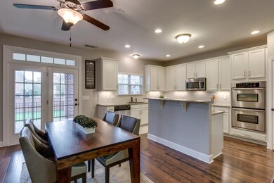 The amazing kitchen has been completely renovated and features bright cabinetry, a new tile back splash, and stainless steel appliances.