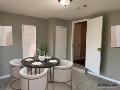 Dining area featuring baseboards and light tile pa