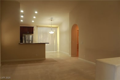 Kitchen with freestanding refrigerator, arched wal