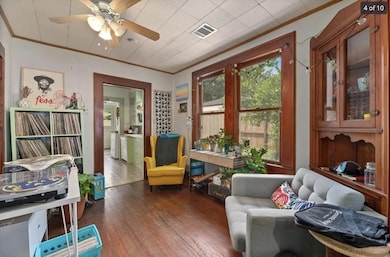 Sitting room with visible vents, a ceiling fan, h