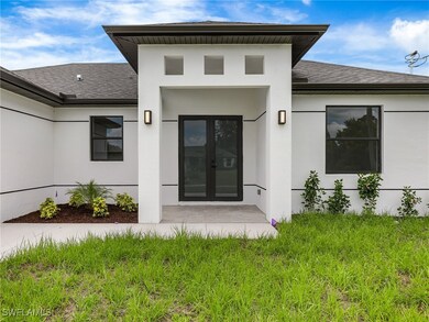 View of exterior entry featuring a shingled roof a
