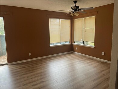 Spare room with a textured ceiling, light wood-typ