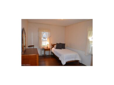 Bedroom with wood floors and large closet space.