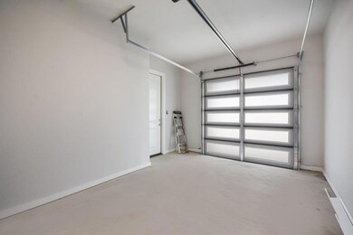Garage featuring baseboards