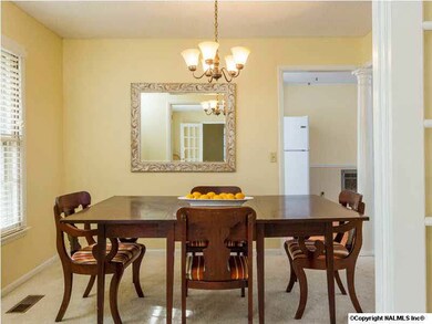 French doors lead you from the formal living room into the formal dining room. A decorative column defines the space between this area and the family room.