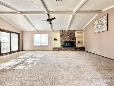 Unfurnished living room featuring a textured ceili