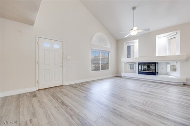 Unfurnished living room featuring high vaulted cei