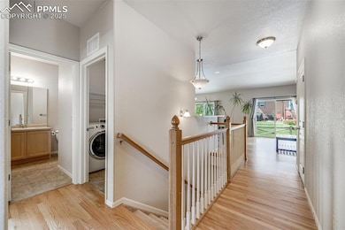 Natural wood floors enhance the entire main level, and a central staircase leads to a full finished basement.