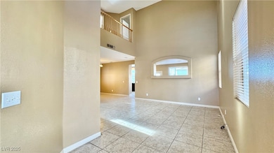 Empty room featuring baseboards, a textured wall,