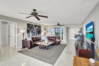 Living room featuring visible vents, ceiling fan, 