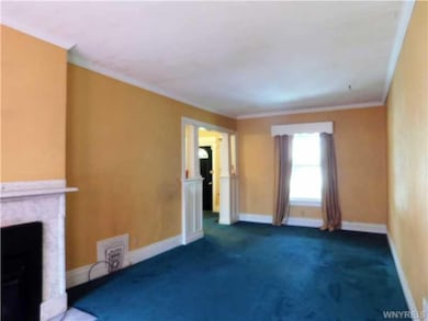 Living Room. There are hardwood floors under carpe