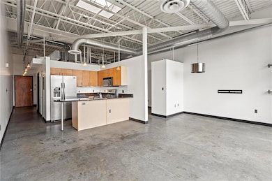 Kitchen with stainless steel refrigerator with ice