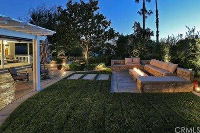 Gorgeous backyard with glass burning fire pit alon