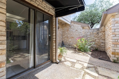 Entrance to property with stone siding