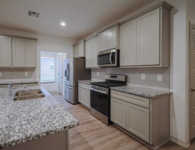 Kitchen featuring appliances with stainless steel 