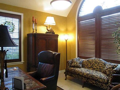 Den. Den with cathedral ceiling, wood blinds and p
