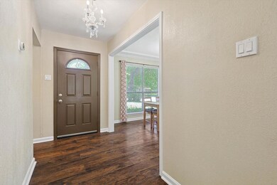 Entrance foyer with vinyl plank flooring and a cha