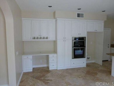 Kitchen desk workspace offers plenty of storage.