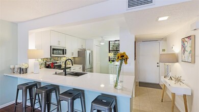 The kitchen is equipped with stainless steel appliances, adding a modern edge.