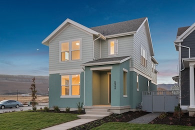 View of front of house featuring a shingled roof, stucco siding, and a gate