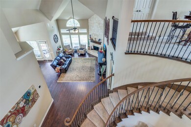 Staircase featuring a towering ceiling, dark wood-