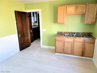 Kitchen with sink and light hardwood / wood-style flooring