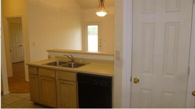 Kitchen with dishwasher, light countertops, light