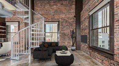 Lofty spiral staircase leads to mezzanine level wi