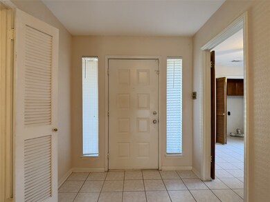 view of front door: tiled entry opens to breakfast