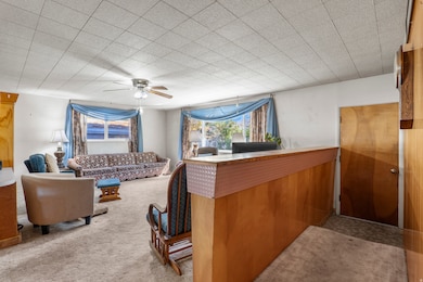 Interior space with carpet and ceiling fan