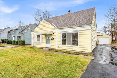 View of front of home with a garage and a front lawn