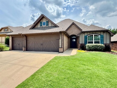 View of front of home with an attached garage, brick siding, driveway, a shingled roof, and a front yard