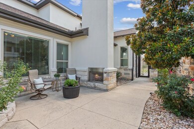 View of patio with an outdoor stone fireplace