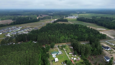 Aerial view of property's location featuring a forest