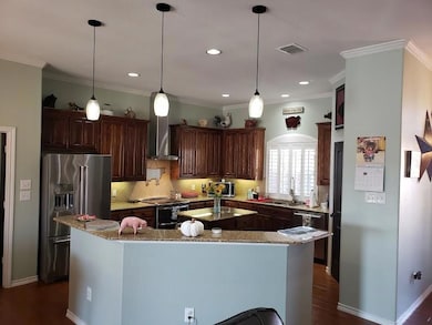 Kitchen with stainless steel appliances, a center