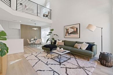 Living room with visible vents, light wood-type f