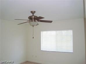 Spare room with ceiling fan