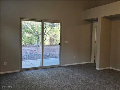 Carpeted spare room featuring baseboards