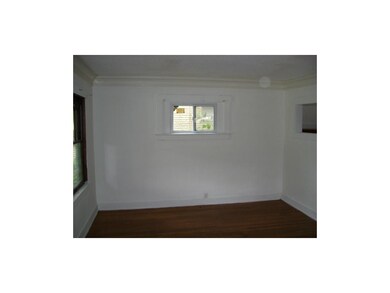 Part of living room showing hard wood floors and n