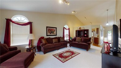 Great room with vaulted ceilings has newer floorin