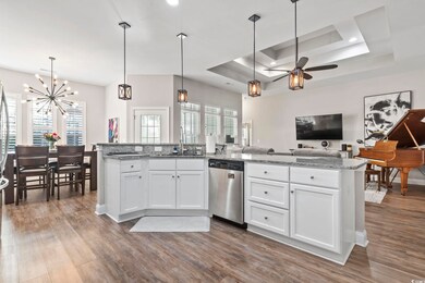 Kitchen with decorative light fixtures, white cabi
