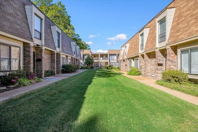 View of property's community featuring a lawn