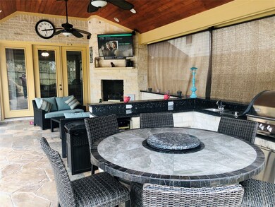 Imagine enjoying the evenings watching tv outside by the gas log fireplace under a custom built patio with custom ceilings, recessed lighting, ceiling fans, outdoor grill, sink and even a built in wine fridge.