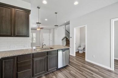 Kitchen with dishwasher, a sink, a ceiling fan, d